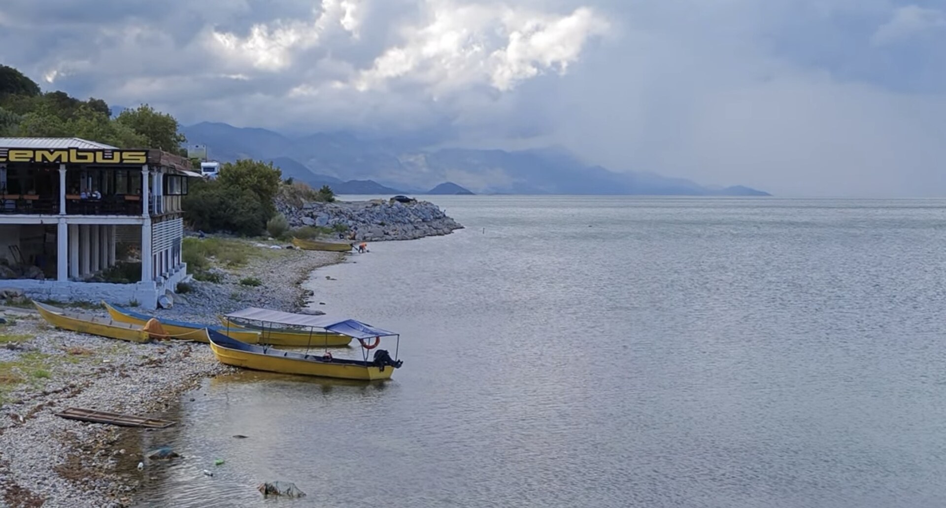 Boats on Lake Shkodër beneath the Albanian Alps