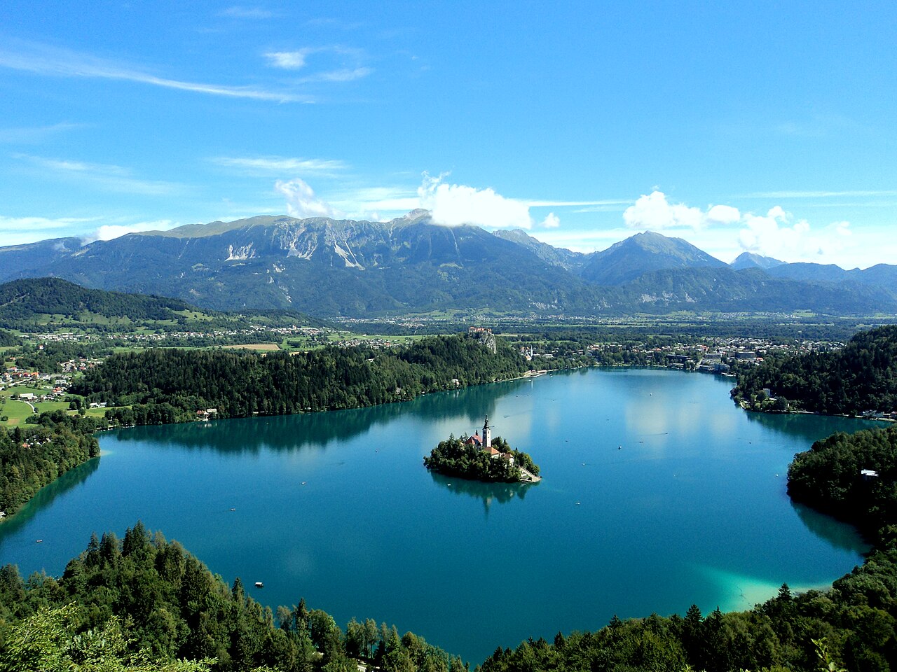 Lake Bled, Slovenia — island church on emerald water with medieval castle on cliff